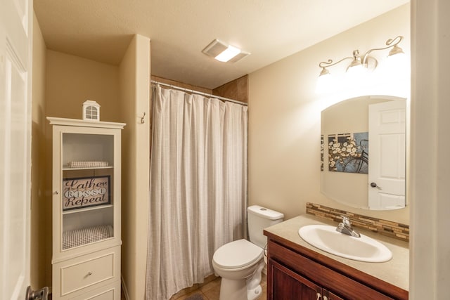 bathroom featuring tile patterned flooring, visible vents, toilet, a shower with shower curtain, and vanity