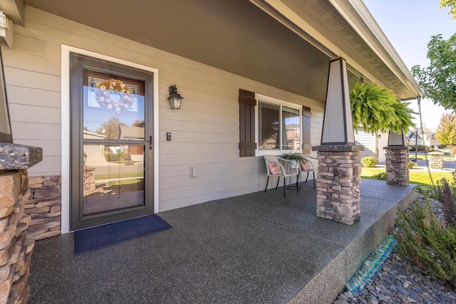 view of exterior entry featuring a porch