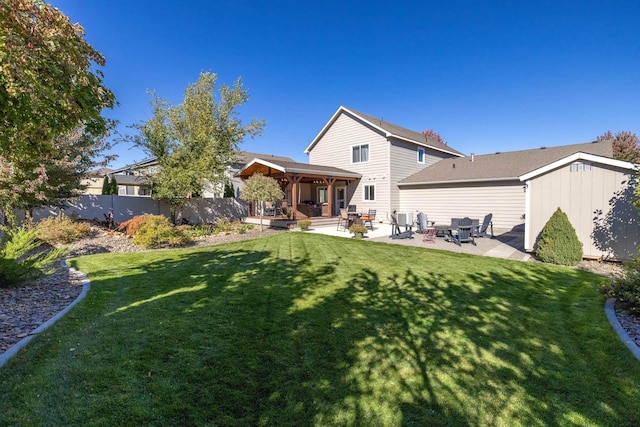 back of house featuring a gazebo, a patio, fence, and a lawn