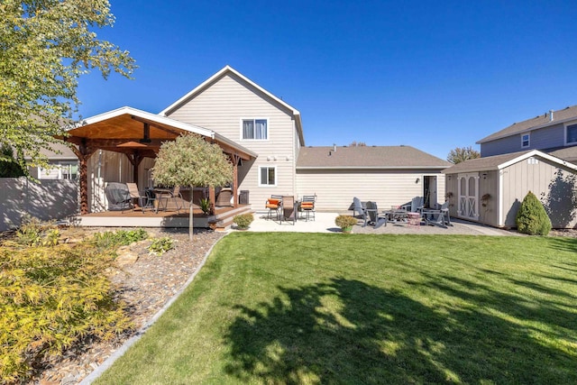 rear view of house featuring an outbuilding, a shed, a gazebo, a yard, and a patio area