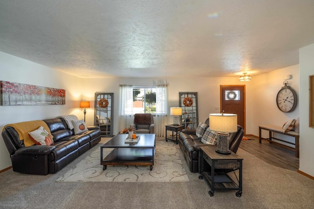 living room with baseboards, a textured ceiling, and carpet flooring