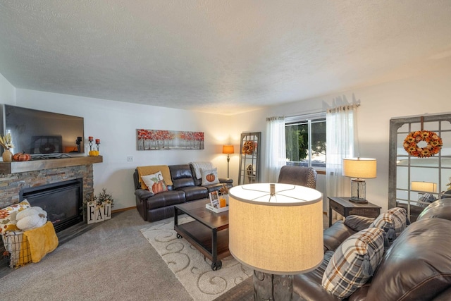 living area featuring carpet flooring, a fireplace, a textured ceiling, and baseboards