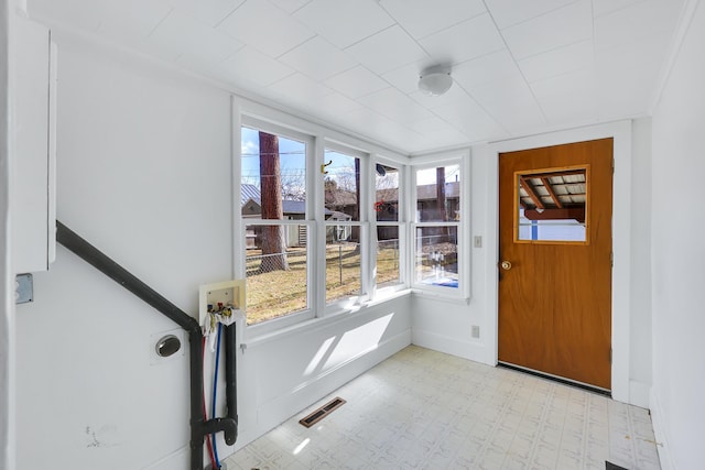 unfurnished sunroom featuring visible vents