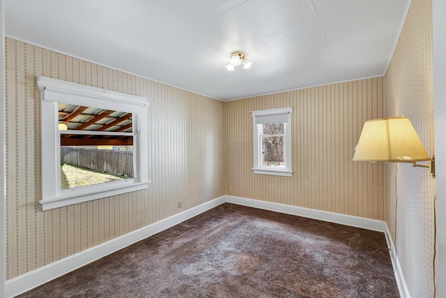 unfurnished room with wallpapered walls, baseboards, and carpet floors