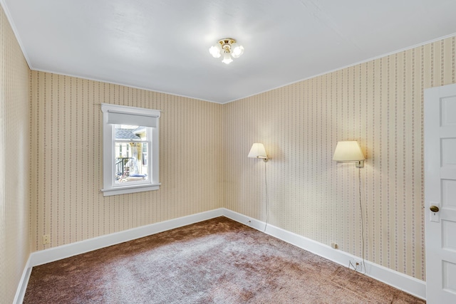 empty room featuring baseboards, carpet floors, and wallpapered walls