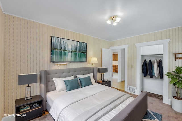 bedroom featuring visible vents, a closet, carpet flooring, wallpapered walls, and baseboards