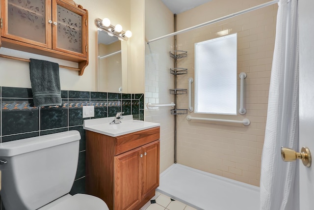 full bathroom featuring a shower stall, tile walls, vanity, and toilet