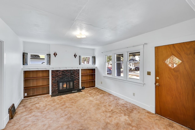 living area featuring light carpet, a fireplace, and baseboards