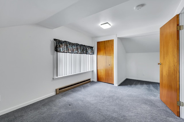 additional living space with baseboards, baseboard heating, vaulted ceiling, and carpet