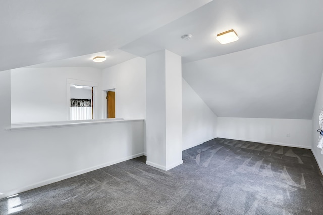 bonus room featuring vaulted ceiling, carpet flooring, and baseboards