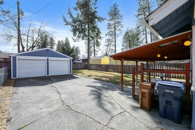 detached garage featuring fence