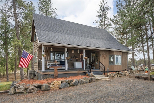 view of front of house featuring a porch, central AC unit, and roof with shingles