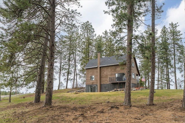 back of house with a yard, a deck, and a chimney