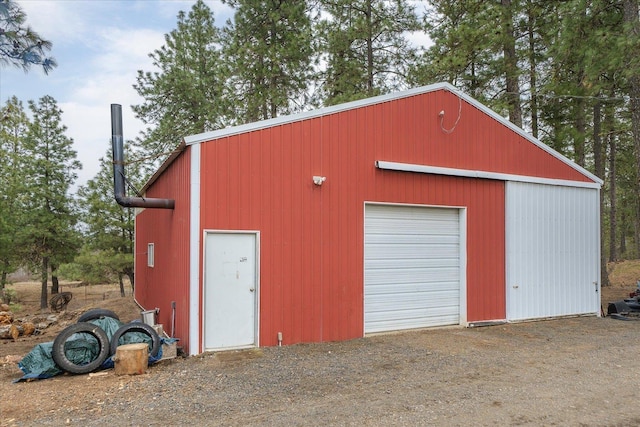 detached garage with dirt driveway