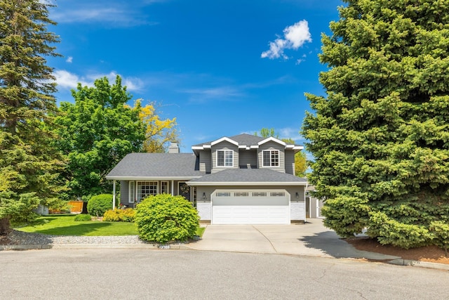 view of front of property with a front lawn, concrete driveway, and an attached garage