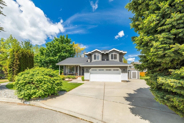 traditional-style home with a storage unit, concrete driveway, and an attached garage