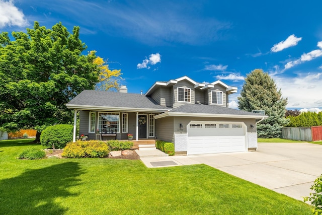 view of front of house featuring a garage, a porch, concrete driveway, and a front yard