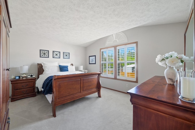 bedroom with a textured ceiling, lofted ceiling, baseboards, and light carpet