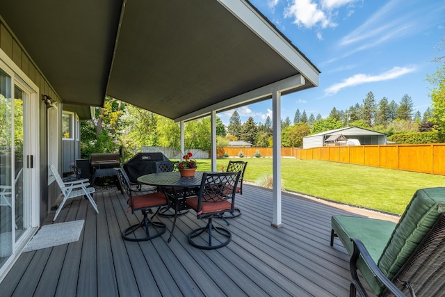 wooden deck featuring a yard, a fenced backyard, and outdoor dining space