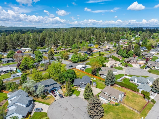 aerial view featuring a forest view and a residential view