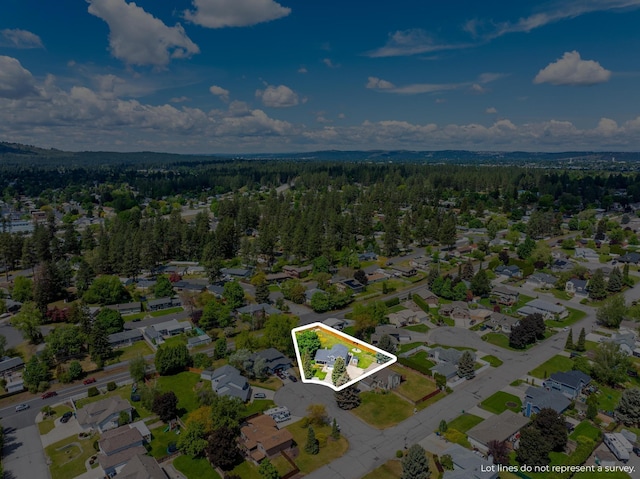 birds eye view of property featuring a residential view and a view of trees