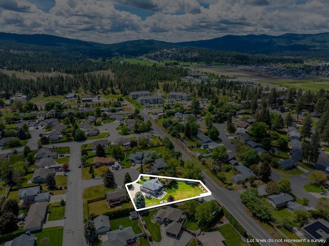 bird's eye view with a mountain view and a view of trees