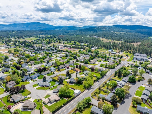 bird's eye view with a forest view and a mountain view