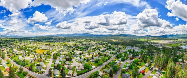 drone / aerial view featuring a residential view and a mountain view