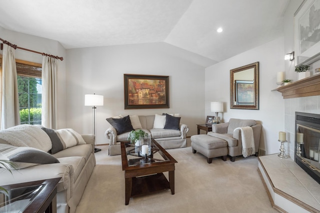 living room with recessed lighting, lofted ceiling, light colored carpet, and a tile fireplace