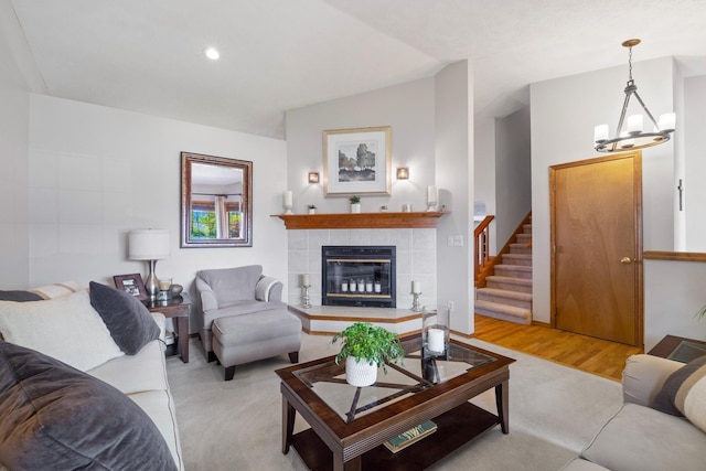 living room featuring stairs, recessed lighting, a fireplace, and light wood-type flooring