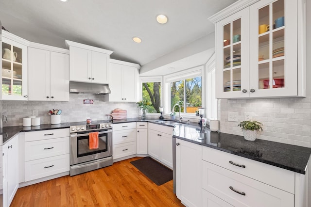 kitchen with under cabinet range hood, stainless steel range with electric cooktop, light wood-style floors, white cabinets, and a sink