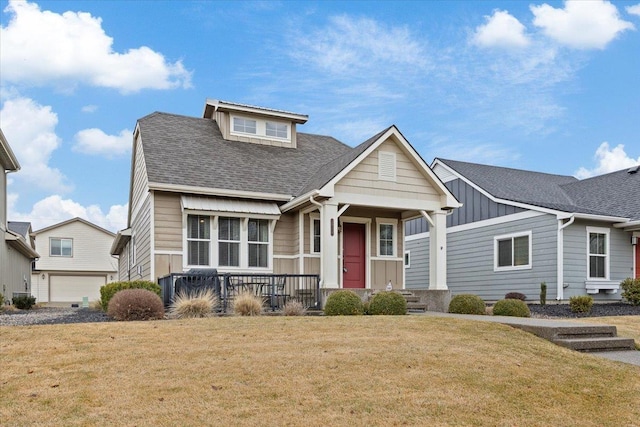 view of front facade with board and batten siding, a front yard, and a shingled roof