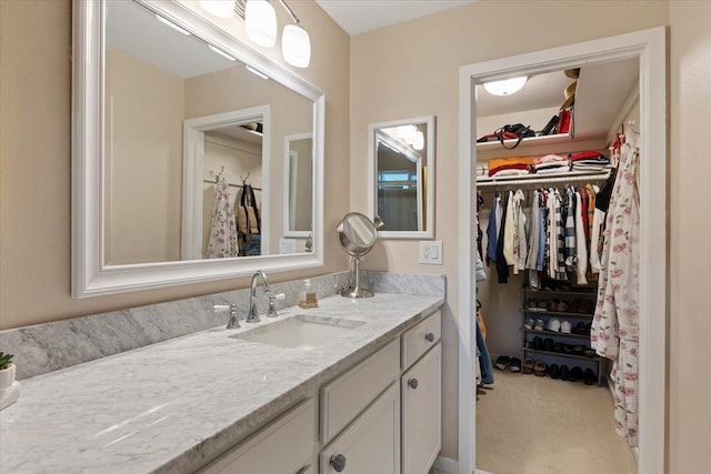 bathroom featuring vanity and a spacious closet