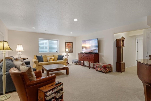 living room with recessed lighting, light colored carpet, and a textured ceiling