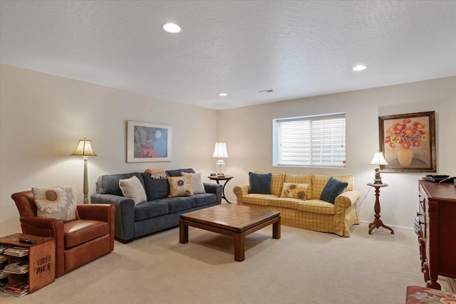 living area featuring recessed lighting, light carpet, and a textured ceiling