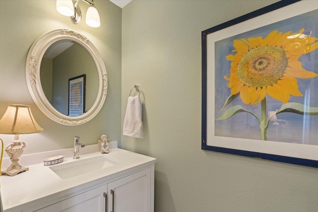 bathroom with vanity and a textured wall