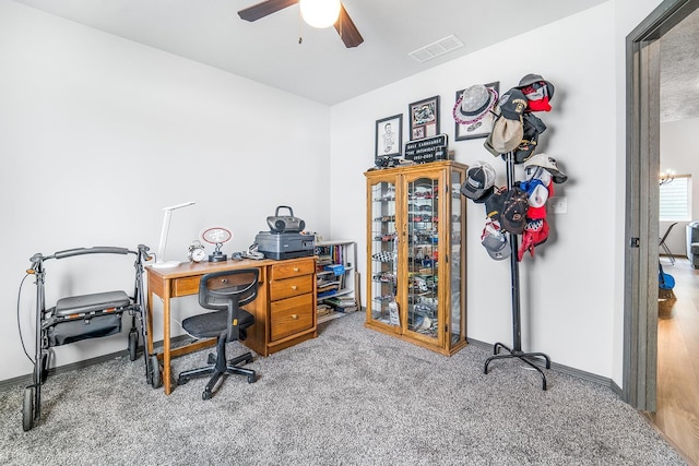 office with visible vents, carpet flooring, baseboards, and ceiling fan