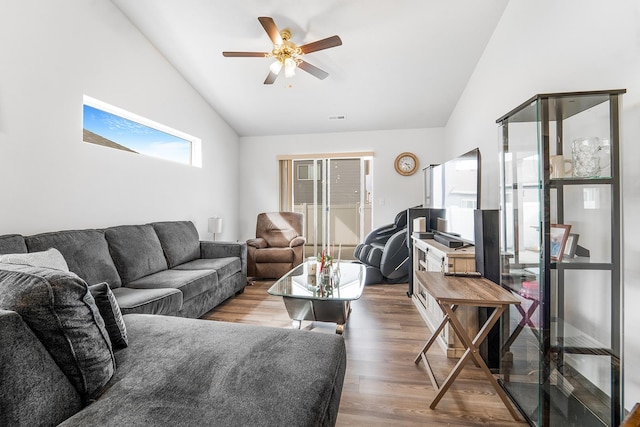 living area featuring wood finished floors, a ceiling fan, and vaulted ceiling