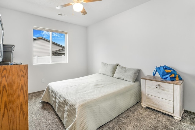 carpeted bedroom with visible vents, baseboards, and a ceiling fan