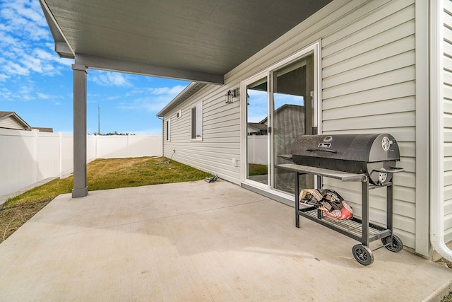 view of patio / terrace with area for grilling and fence