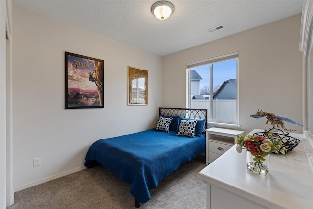 bedroom with light carpet, visible vents, a textured ceiling, and baseboards