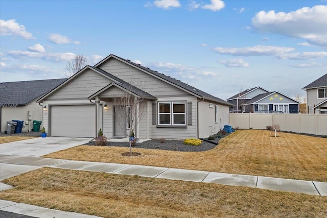 view of front of house with driveway, a front yard, an attached garage, and fence