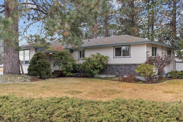 view of side of home with a lawn