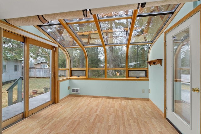 unfurnished sunroom featuring visible vents