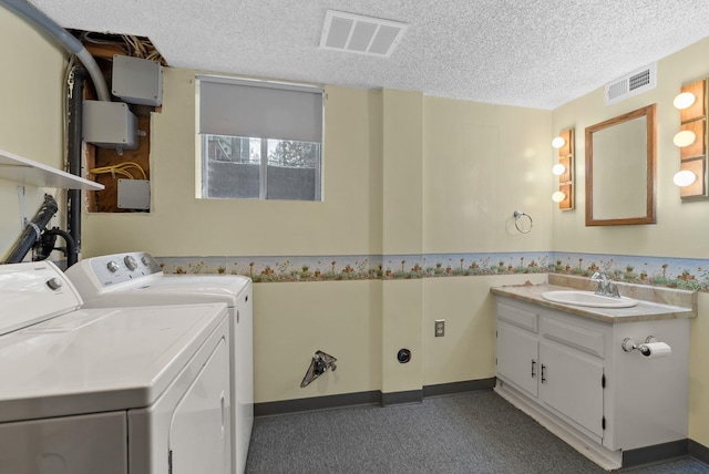 laundry area featuring visible vents, washing machine and dryer, laundry area, and a sink