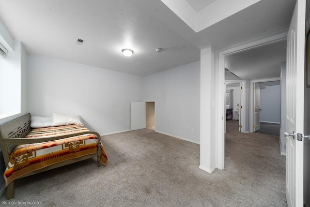 carpeted bedroom featuring baseboards and visible vents