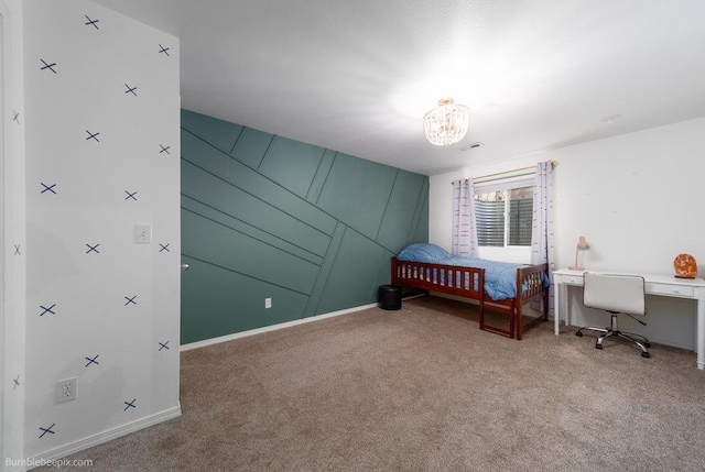 carpeted bedroom featuring baseboards and an inviting chandelier