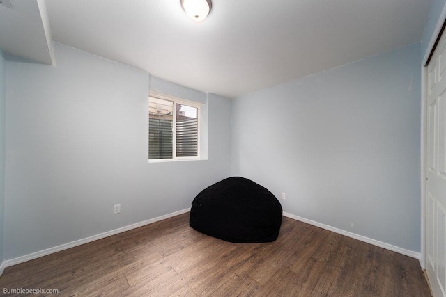 interior space with baseboards and wood finished floors