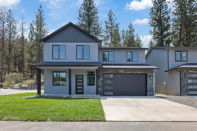 view of front of home with a front lawn, driveway, stone siding, covered porch, and a garage