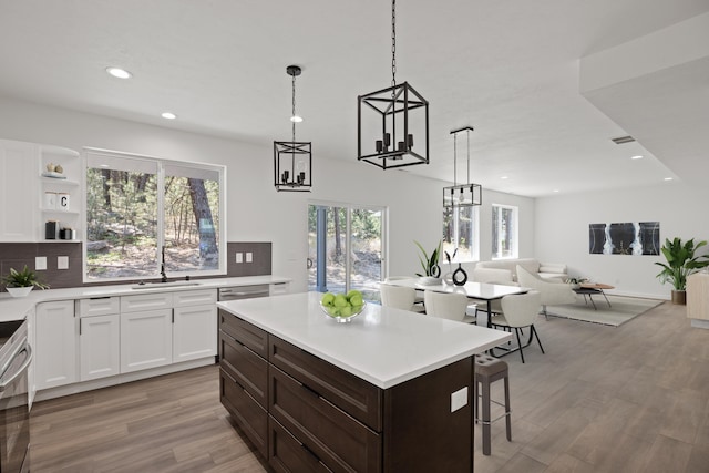 kitchen featuring decorative backsplash, light wood-style flooring, and light countertops